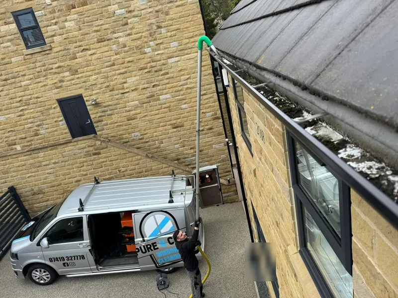 Pure4clean van and gutter vacuum outside a stone house