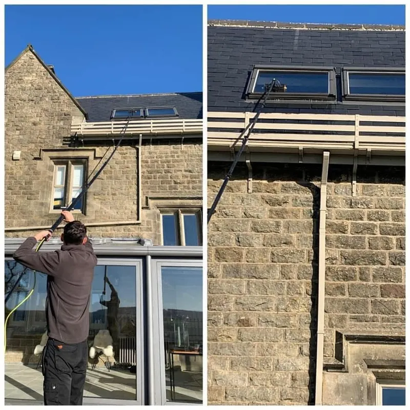 Window cleaner using a water-fed pole on the windows of a stone house